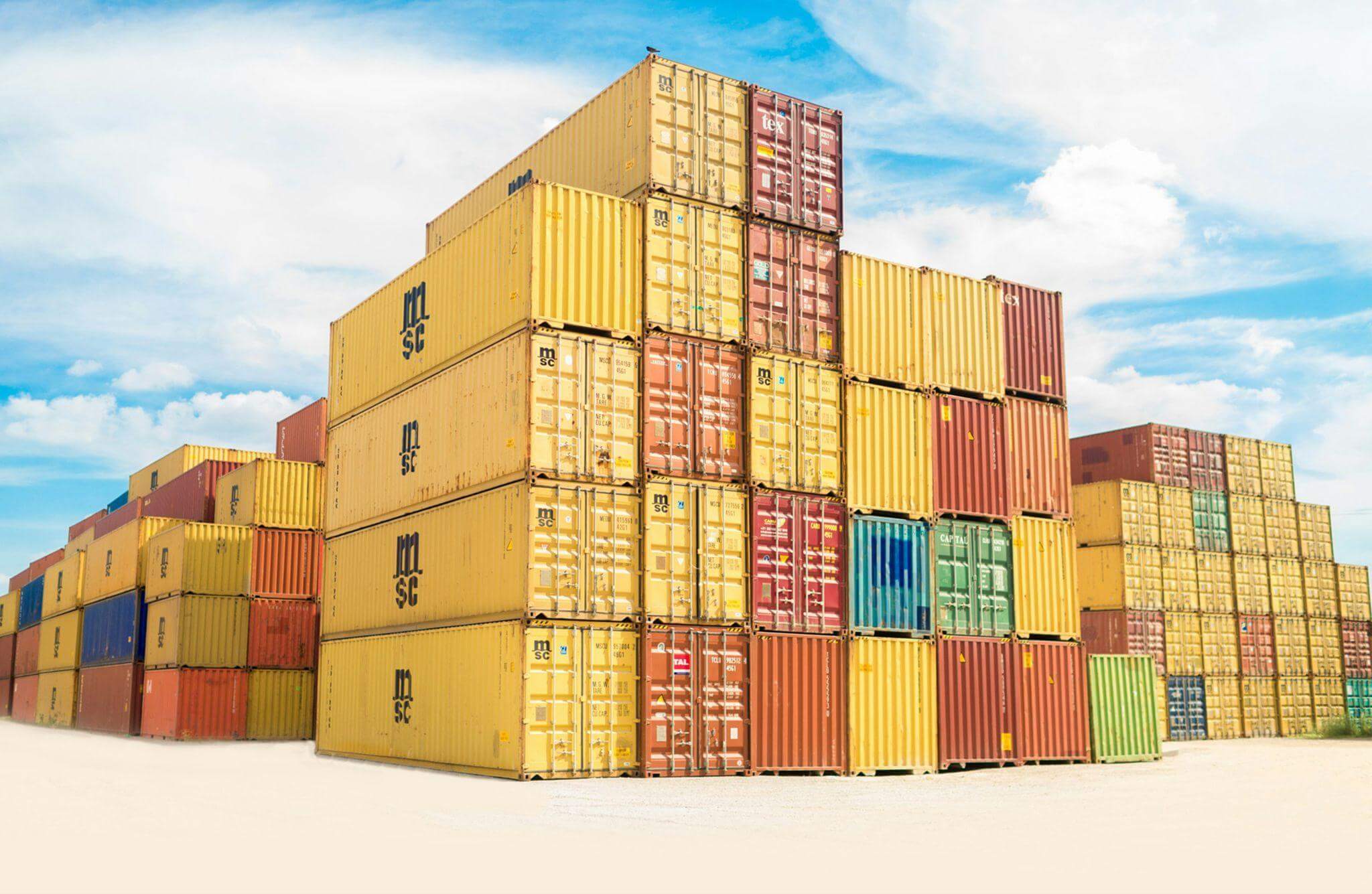 Stacked shipping containers in a logistics yard for industrial battery storage and transport