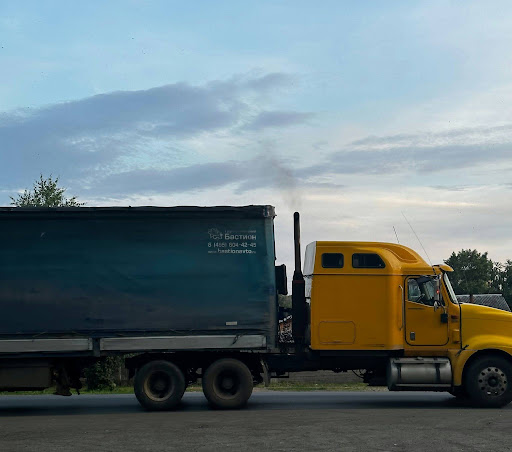 A truck carrying freight travels a highway, representing the hazmat shipments that can be flagged for a DOT or PHMSA enforcement review.